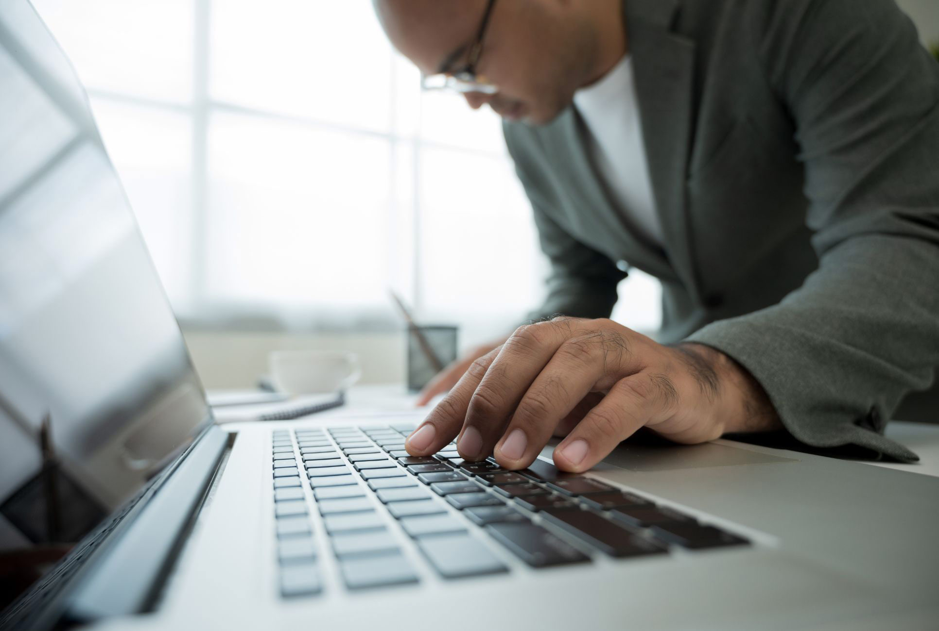 Close up Businessman hands working in office with laptop. Businessman typing the keyboard and planning the project.