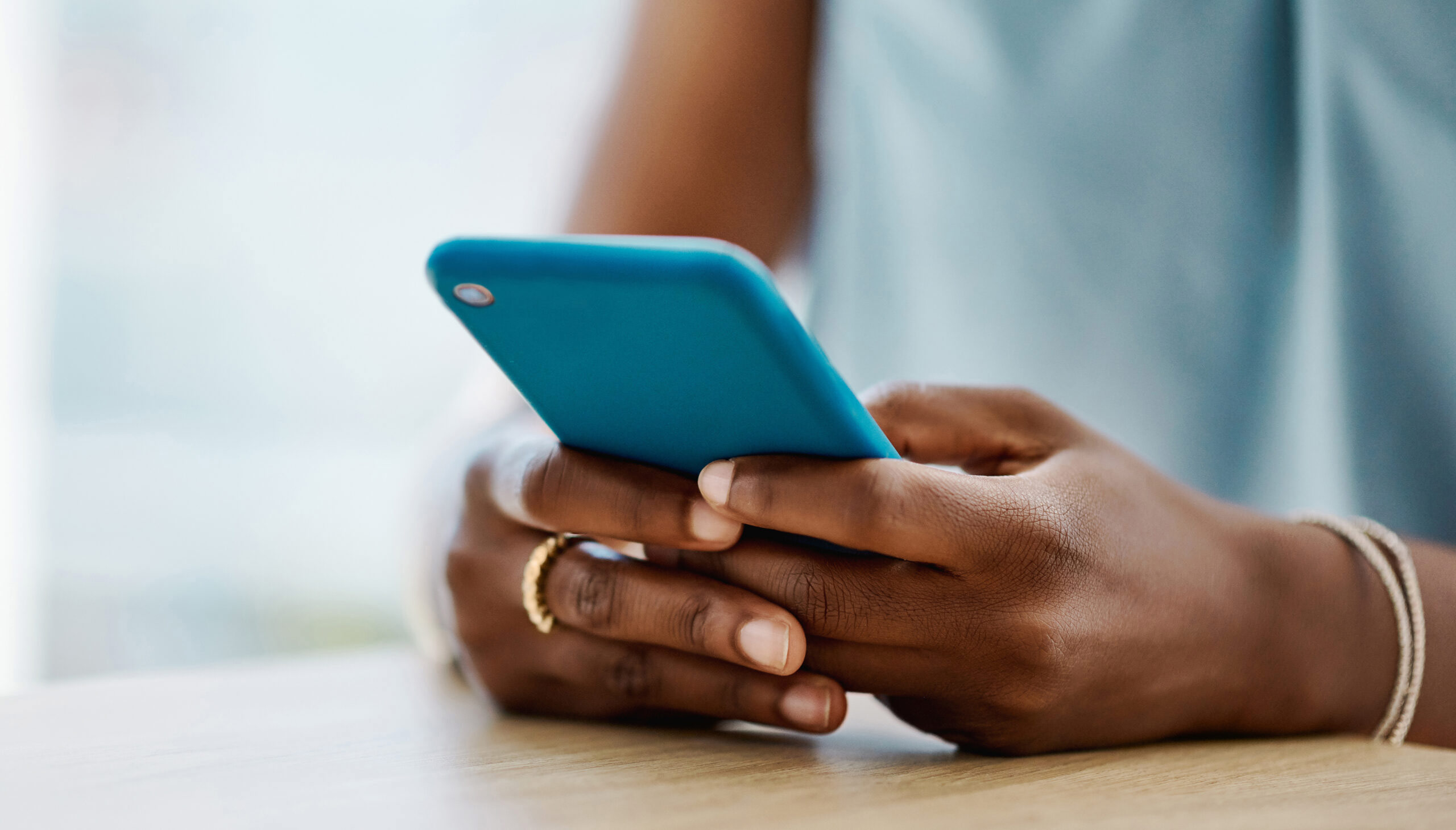 African woman using a cellphone in an office alone